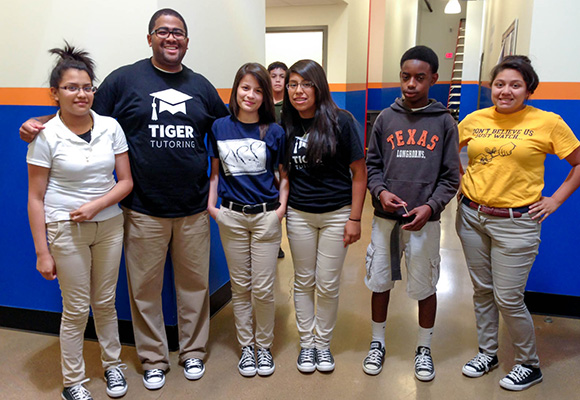 Back teaching in his home state of Texas, Dexter poses with students at KIPP Truth Academy.