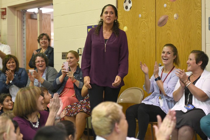 Aimee Schade surrounded by colleagues