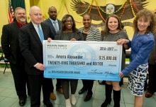 Amara Alexander check with dignitaries