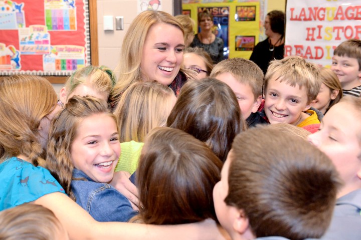 Angela Harvala hugged by students