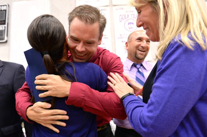 Bill Smithyman hugs colleague