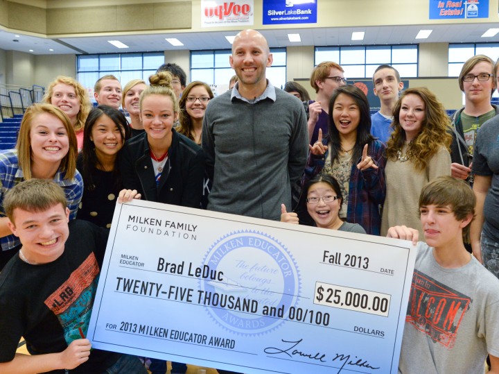 Brad LeDuc with students and check