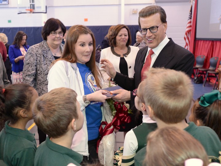 Catherine Randall shows students award envelope