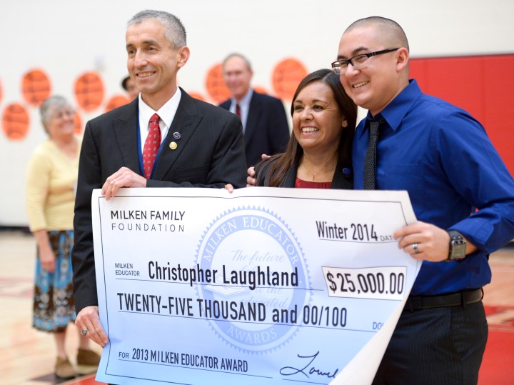 Christopher Laughland with Dr Manuel Valenzuela Principal Teresa Hill and 25000 check