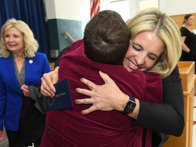 Council Oak Aubrey Flowers colleagues hug