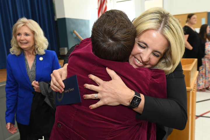 Council Oak Aubrey Flowers colleagues hug