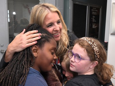 Council Oak Aubrey Flowers students hug