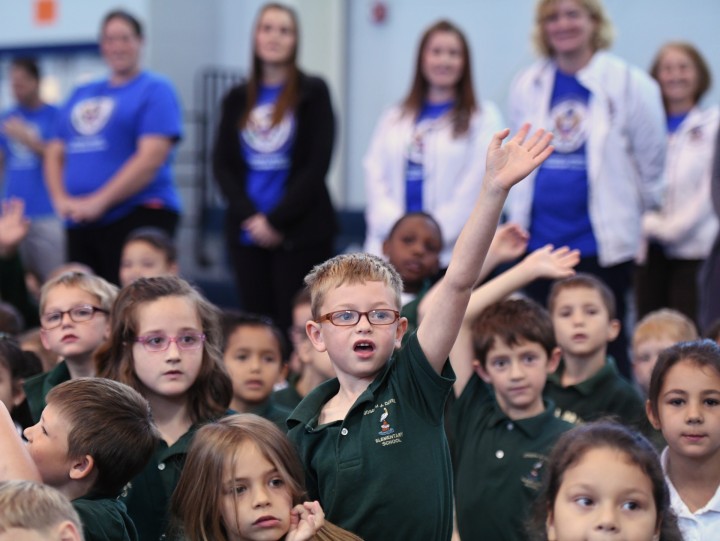 Davies students raise hands with teachers