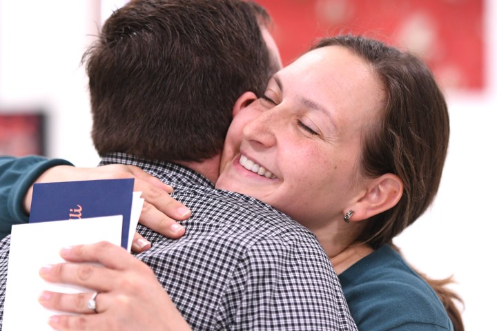 Emily Caldarelli hugs colleague