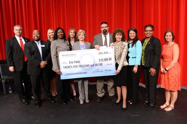 Eric Patin with Milken Award check