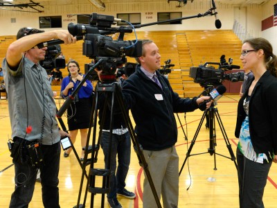 Gina Benz talks with reporters