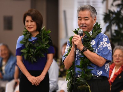 Governor David Ige congratulates Kelly Sutcliffe