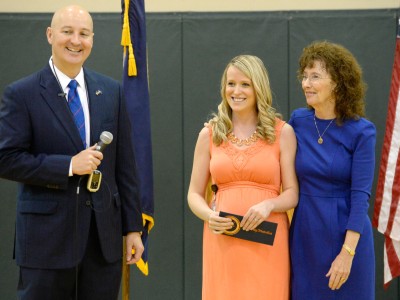 Governor Pete Ricketts and Jane Foley congratulate Courtney Matulka