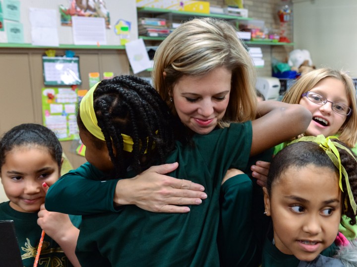 Jessica Tsoufiou hugged by students