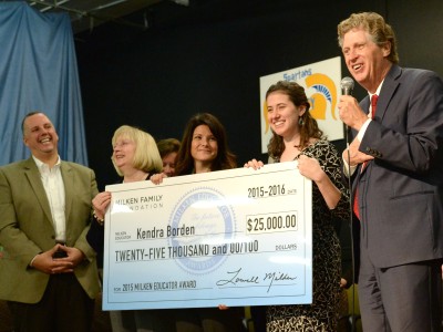 Kendra Borden holds check with veteran Milken Educators