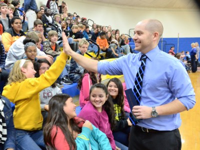 Kevin Winters high fives student