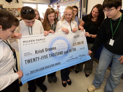 Kristi Grooms students hold check