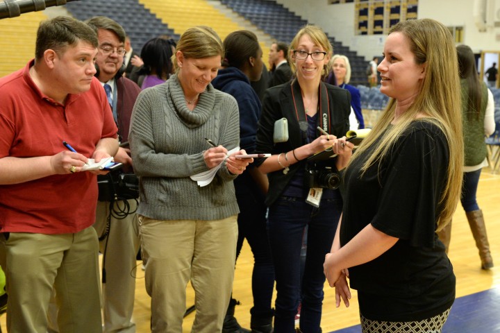 Lauren Wilson talks with reporters