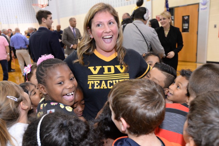 Lindsay Frevert surrounded by students