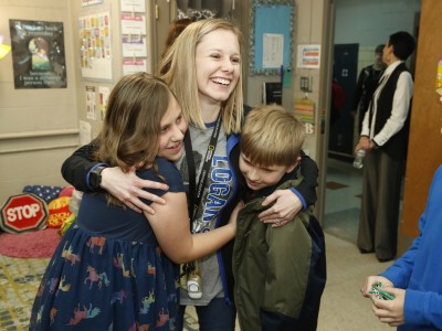 Logan Kristine Becker students hug