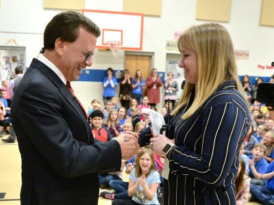 Lowell Milken congratulates Felicia Casto