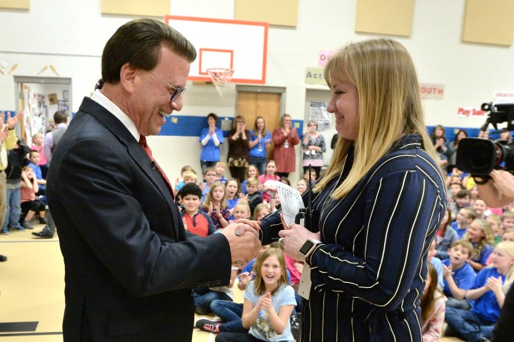 Lowell Milken congratulates Felicia Casto