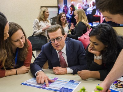 Lowell Milken helps Milken Educators choose panels MEA Forum 0324