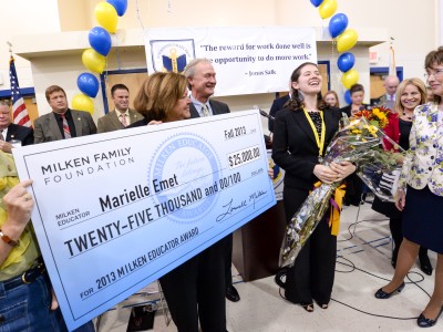 Marielle Emet receives check and cheers