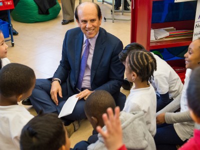 Michelle Johnson Mike Milken gets autographs from students