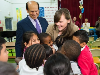 Michelle Johnson hugged by students with Mike Milken