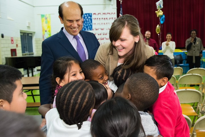 Michelle Johnson hugged by students with Mike Milken