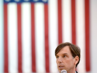Mike Sinclair speaks with flag
