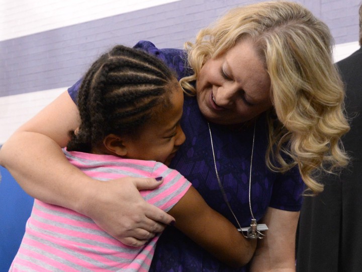 Stephanie Conklin hugs student