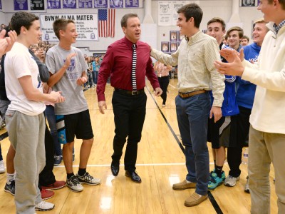 Students help Bill Smithyman to his feet