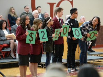 Students show Milken Award amount