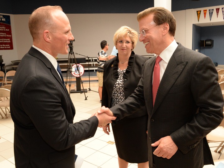 Tobin Schultz and Lowell Milken shake hands