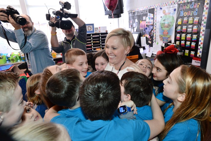 Traci Druschke with students group hug