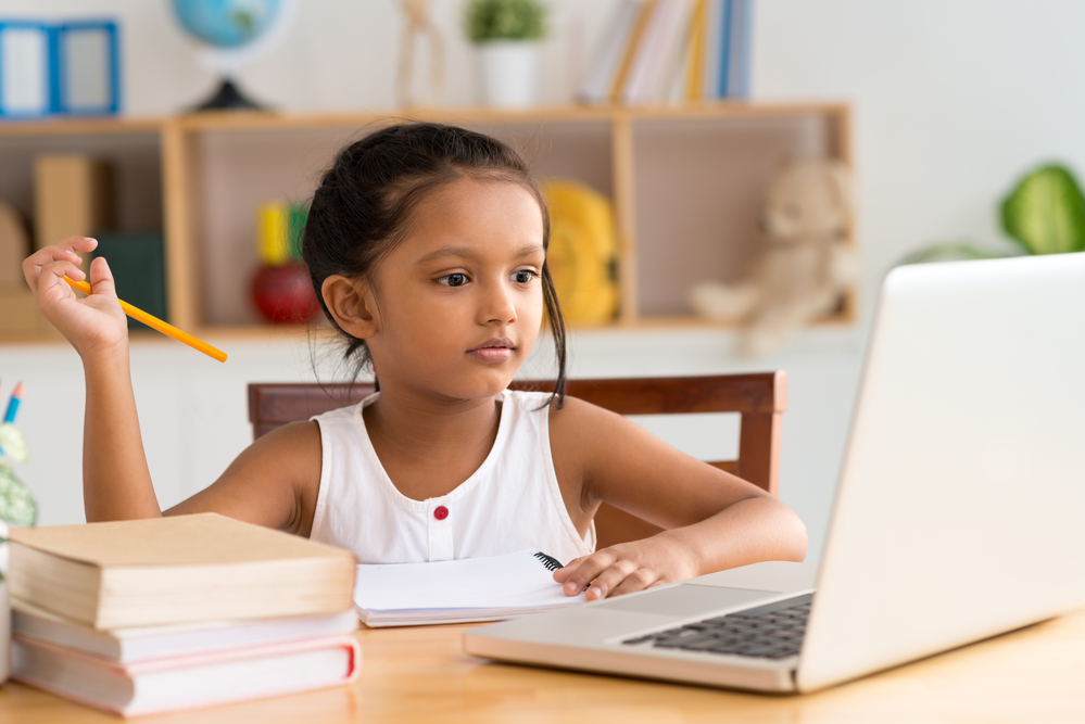 Girl engaged in distance learning 1000w