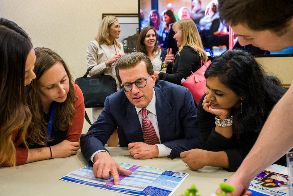 Lowell Milken helps Milken Educators choose panels MEA Forum 0324 1000w