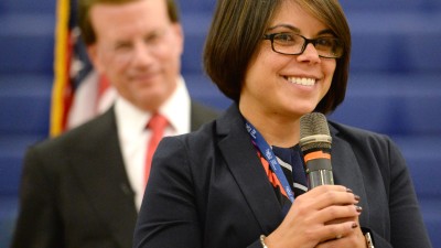 Kimberly Moreno addresses students as Lowell Milken looks on